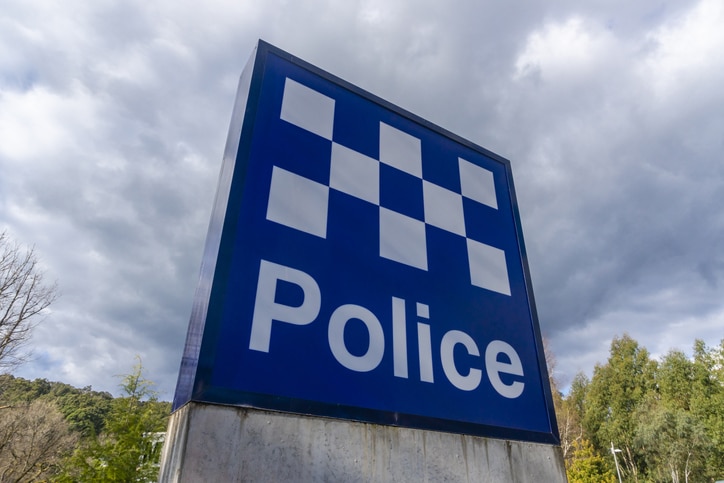 blue and white check sign of a police station in Australia