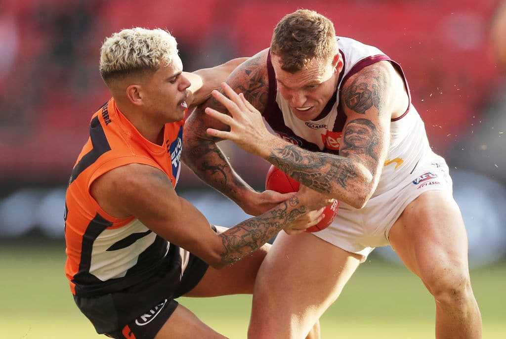 SYDNEY, AUSTRALIA - JULY 18: Mitch Robinson of the Lions is tackled by Ian Hill of the Giants during the round 7 AFL match between the Greater Western Sydney Giants and the Brisbane Lions at GIANTS Stadium on July 18, 2020 in Sydney, Australia. (Photo by Matt King/AFL Photos/via Getty Images)