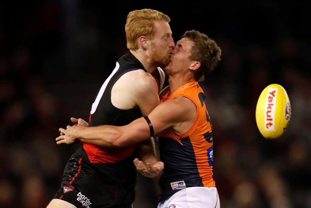 MELBOURNE, AUSTRALIA - JUNE 27: Harry Perryman of the Giants and Aaron Francis of the Bombers clash heads during the 2019 AFL round 15 match between the Essendon Bombers and the GWS Giants at Marvel Stadium on June 27, 2019 in Melbourne, Australia. (Photo by Michael Willson/AFL Photos via Getty Images)