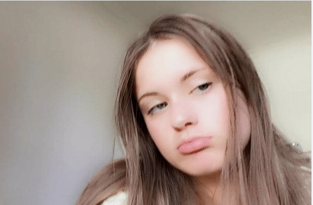 13-year-old girl with long brown hair pouting