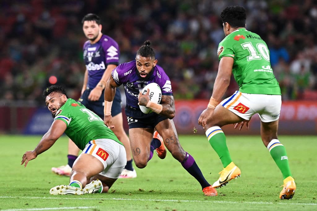 BRISBANE, AUSTRALIA - OCTOBER 16: Josh Addo-Carr of the Storm is tackled during the NRL Preliminary Final match between the Melbourne Storm and the Canberra Raiders at Suncorp Stadium on October 16, 2020 in Brisbane, Australia. (Photo by Bradley Kanaris/Getty Images)