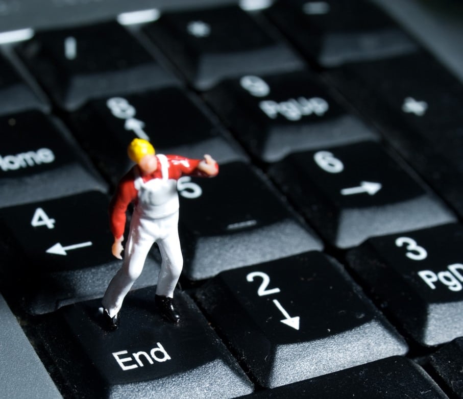 small human figurine on 'End' button on computer keypad to illustrate a letter to the editor about euthanasia