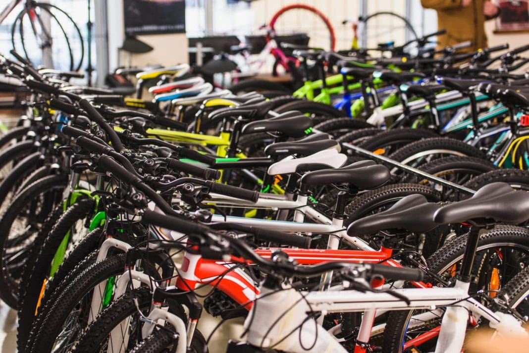 rows of new bikes lined up neatly in a bike shop