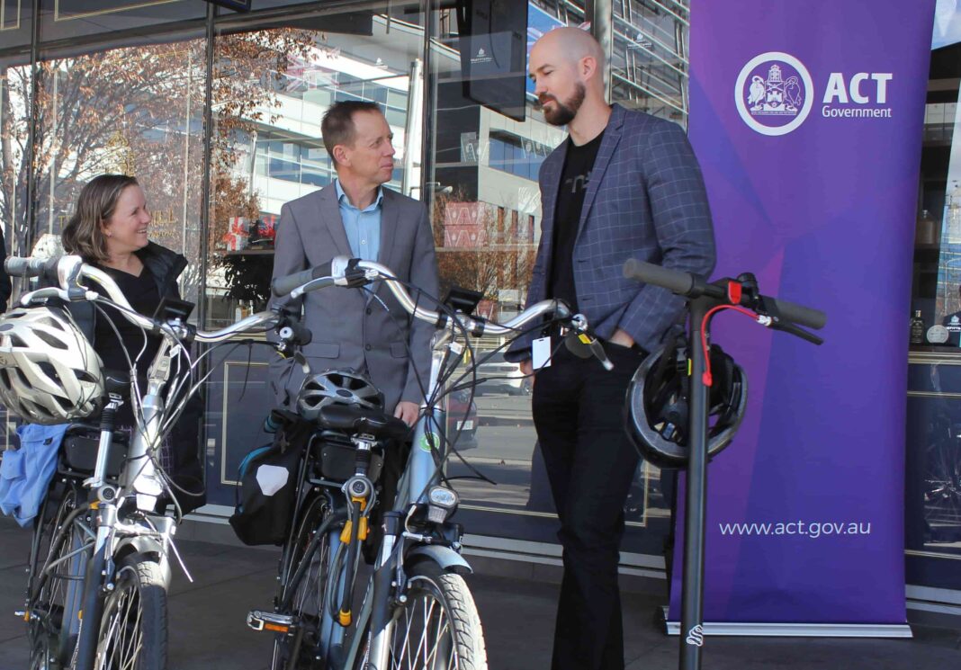 Helen Oakey, Conservation Council ACT Region’s executive director, and Shane Rattenbury, ACT Minister for Water, Energy and Emissions Reduction, with Tim Berman, prospective electric bike buyer. Photo: Nick Fuller