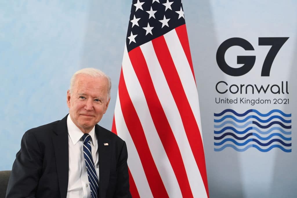 US President Joe Biden in front of a US flag