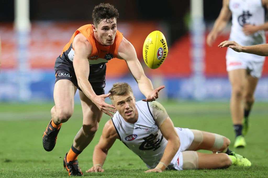 GOLD COAST, AUSTRALIA - SEPTEMBER 03: Lachlan Ash of the Giants gathers the ball during the round 15 AFL match between the Greater Western Sydney Giants and the Carlton Blues at Metricon Stadium on September 03, 2020 in Gold Coast, Australia. (Photo by Chris Hyde/Getty Images)