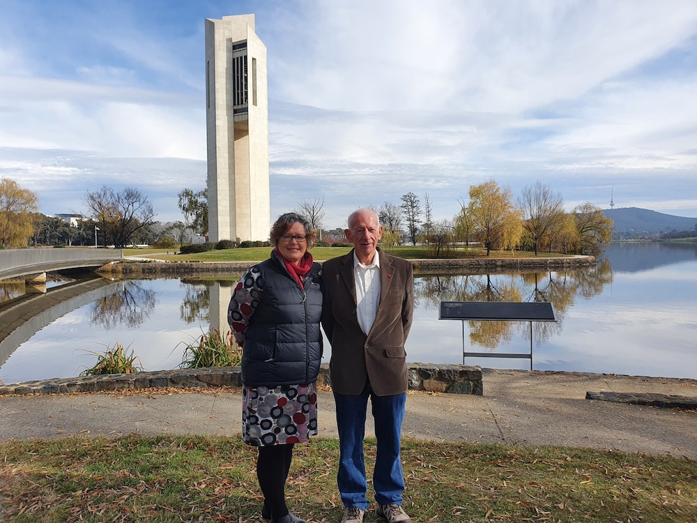 woman and man standing near the National Carillon beside Lake Burley Griffin in Canberra