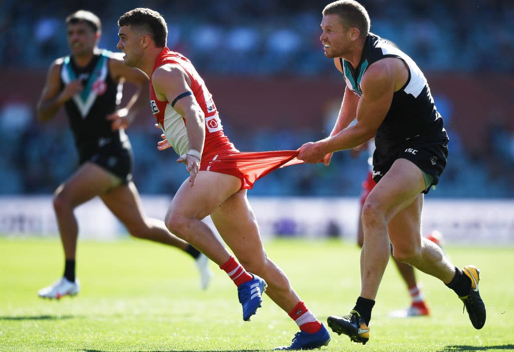 ADELAIDE, AUSTRALIA - AUGUST 29: Tom Papley of the Swans caught by the shorts by Tom Clurey of Port Adelaide during the round 14 AFL match between the Port Adelaide Power and the Sydney Swans at Adelaide Oval on August 29, 2020 in Adelaide, Australia. (Photo by Mark Brake/Getty Images)
