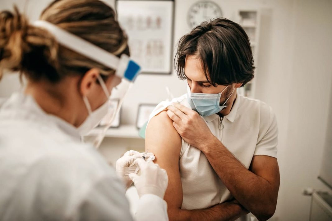 man getting covid vaccine