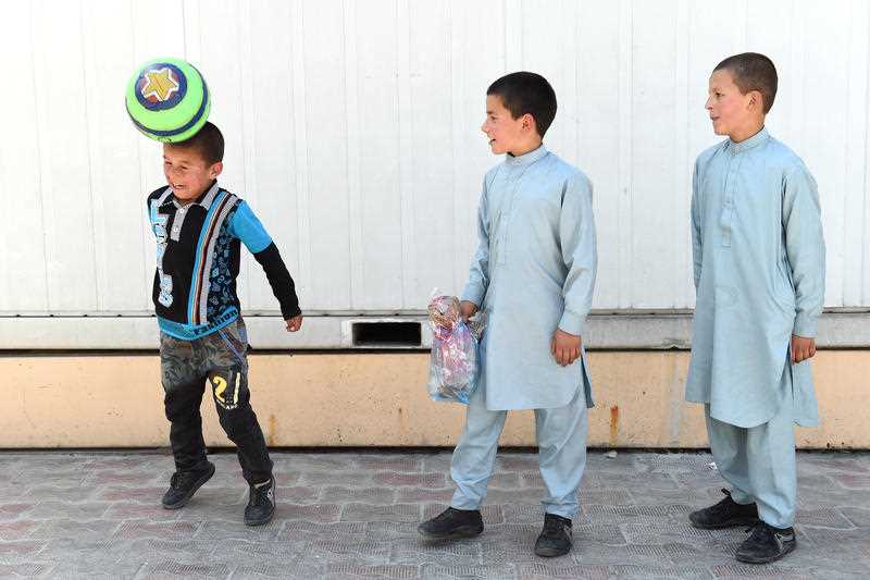 3 orphaned Afghani boys play during a visit to an Australian Embassy residence in Kabul, Afghanistan in April