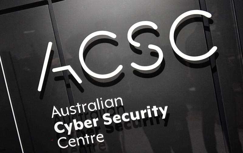 White ACSC Australian Cyber Security Centre signage on a black wall