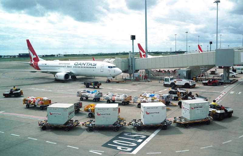 Qantas ground staff are seen operating on the tarmac at the Brisbane domestic terminal