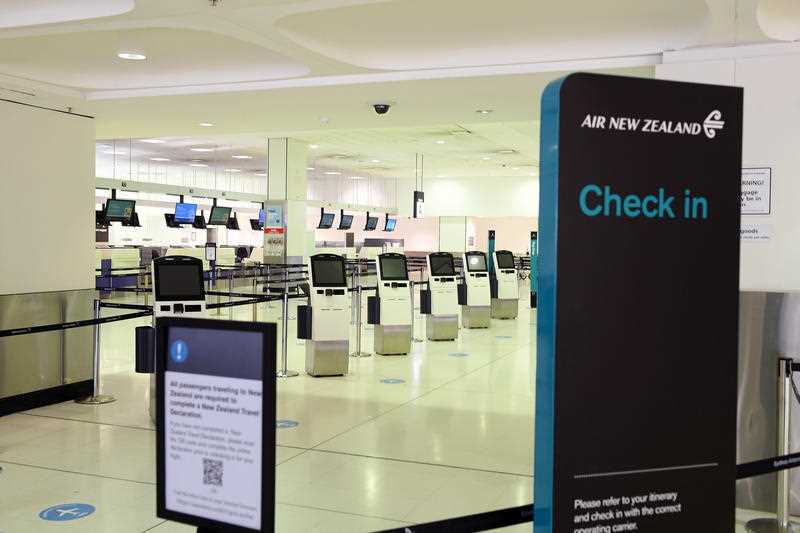 a deserted Air New Zealand check in counter is seen at Sydney International Airport