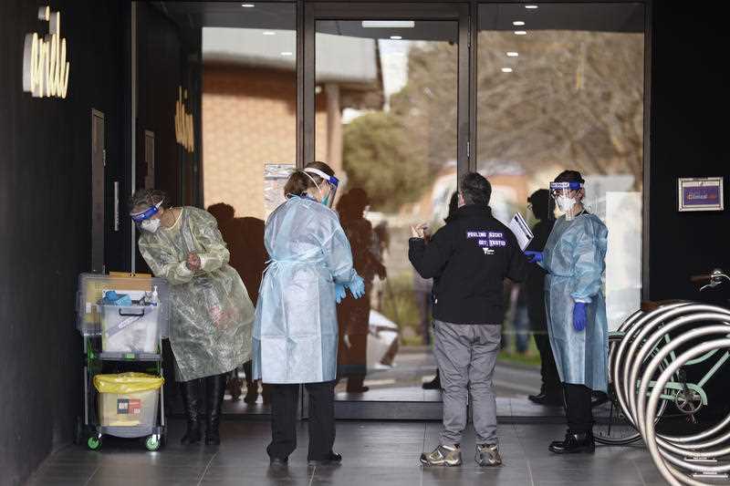 Vic Health personnel prepare to enter Ariele Apartments in Maribyrnong, Melbourne, Tuesday, July 13, 2021. An apartment building in Melbourne’s north-west has been locked down after a covid positive Sydney-based removalist team visited the site
