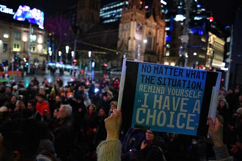 crowd staging lockdown protest in Melbourne at night
