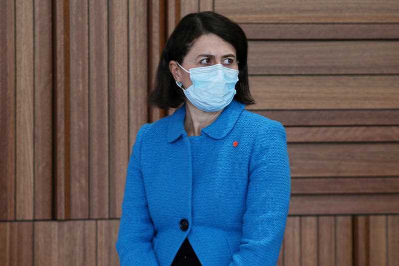NSW Premier Gladys Berejiklian, wearing a face mask, looks on during a COVID-19 update and press conference in Sydney