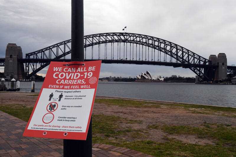 A Covid sign warning is seen at a ferry wharf in Sydney