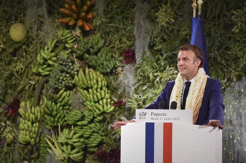 France's President Emmanuel Macron wearing a flower lei and seashell necklaces delivers a speech after a meeting with the President of the French Polynesia Edouard Fitch in Tahiti