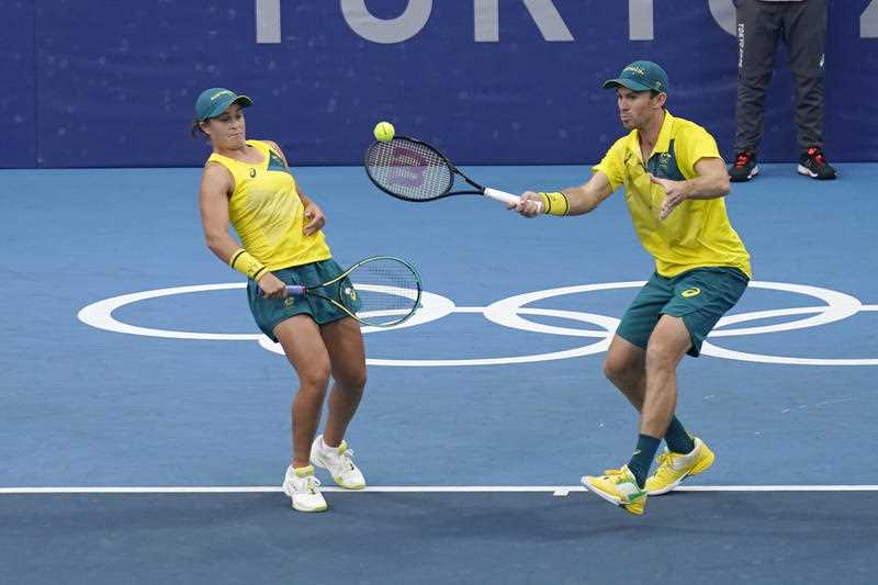 The Australian doubles team of Ashleigh Barty, left, and John Peers play during a semifinals match of the tennis competition at the 2020 Summer Olympic
