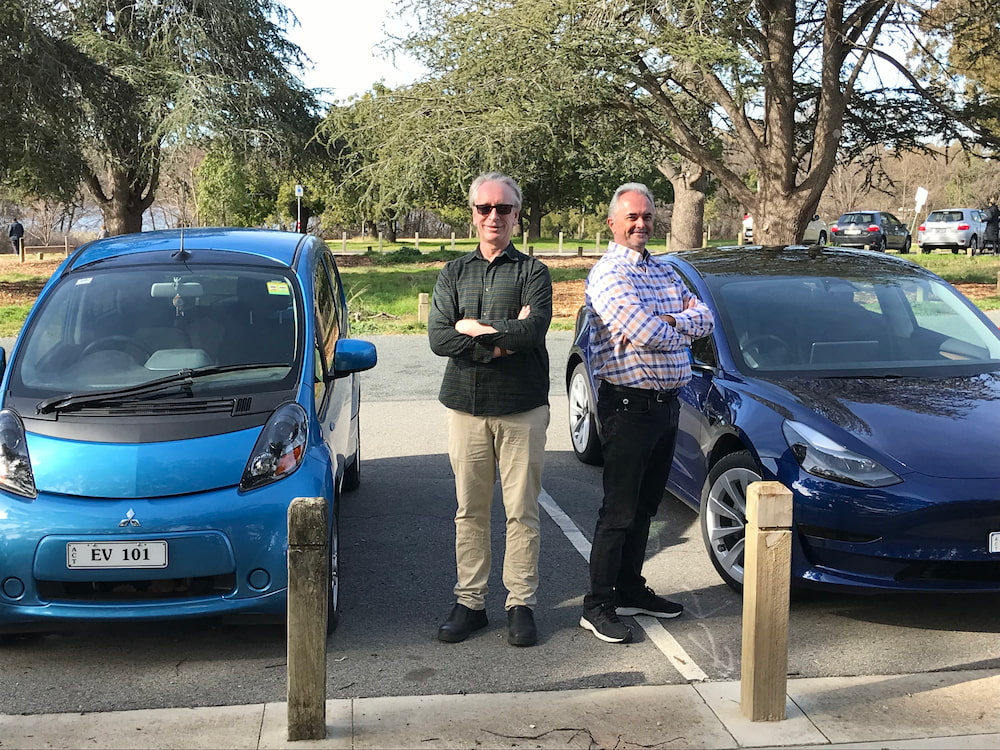 Karl Goiser and Peter McNeil with their electric vehicles. Picture: Nick Fuller
