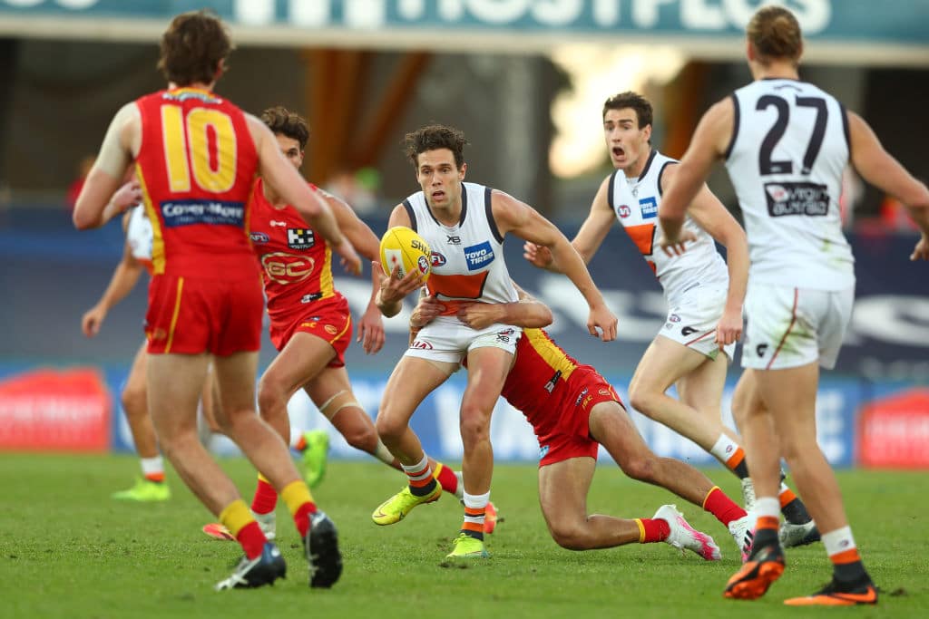 GOLD COAST, AUSTRALIA - AUGUST 02: Josh Kelly of the Giants handballs during the round nine AFL match between Gold Coast Suns and the Greater Western Sydney Giants at Metricon Stadium on August 02, 2020 in Gold Coast, Australia. (Photo by Chris Hyde/AFL Photos/via Getty Images)