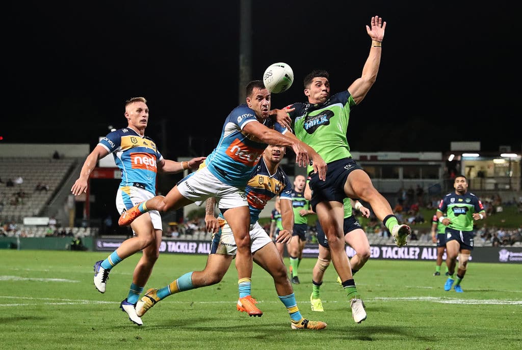 SYDNEY, AUSTRALIA - APRIL 03: Corey Thompson of the Titans and Bailey Simonsson of the Raiders compete for a high ball during the round four NRL match between the Gold Coast Titans and the Canberra Raiders at Netstrata Jubilee Stadium, on April 03, 2021, in Sydney, Australia. (Photo by Mark Metcalfe/Getty Images)