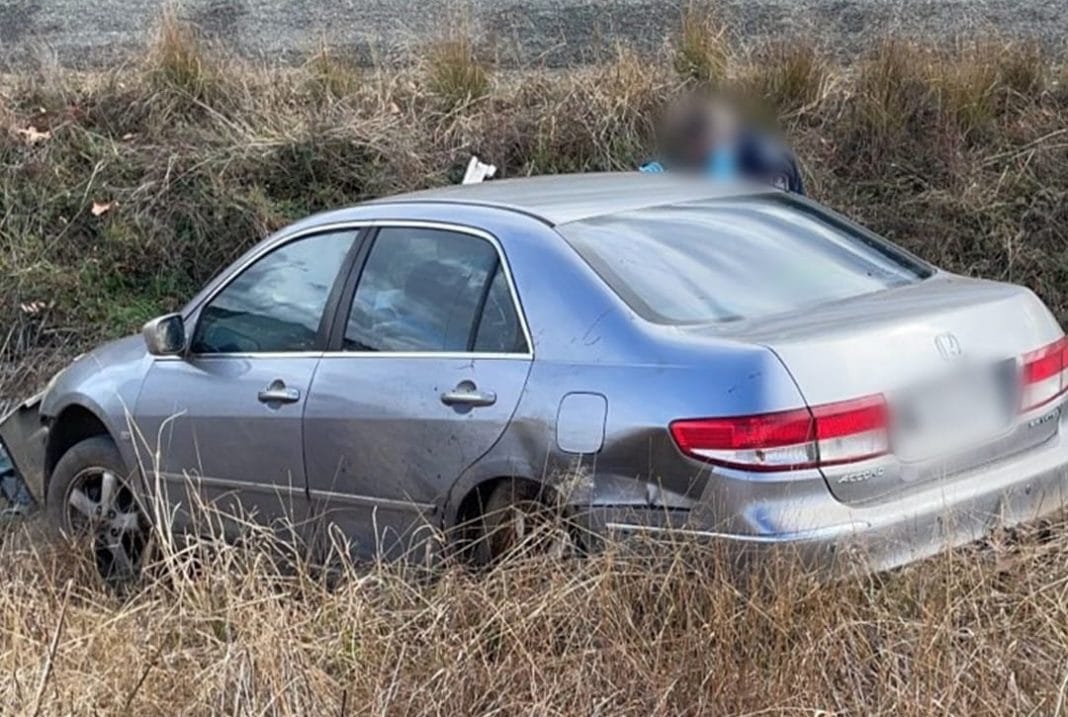 2006 silver Honda Accord sedan crashed in a roadside ditch