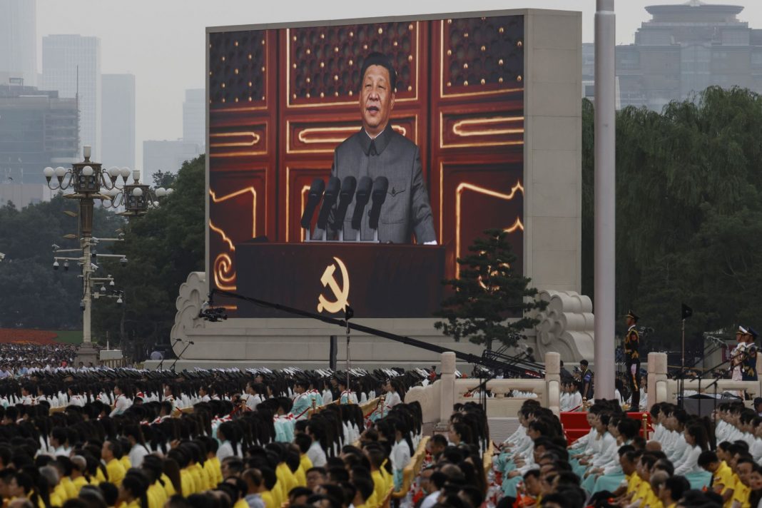 Chinese President Xi Jinping broadcast on a big screen in front of huge crowds in Tiananmen Square