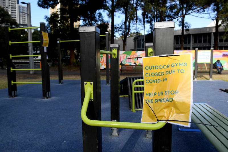 'help us stop the spread' signs on a closed playground
