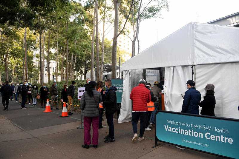 People are seen lining up at the Mass vaccination hub at Olympic Park in Sydney