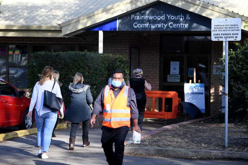 Teachers and education staff are seen arriving at a mass vaccination hub located at Prairiewood Youth and Community Centre, in Sydney