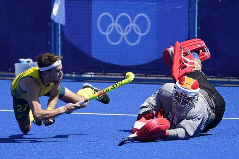 Australia's Flynn Andrew Ogilvie (22) scores on Netherlands goalkeeper Pirmin Blaak (26) in a shoot-out during a men's field hockey match at the 2020 Summer Olympics