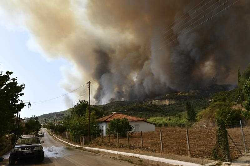 Flames burn a mountain over Pelopio village, near ancient Olympia, western Greece