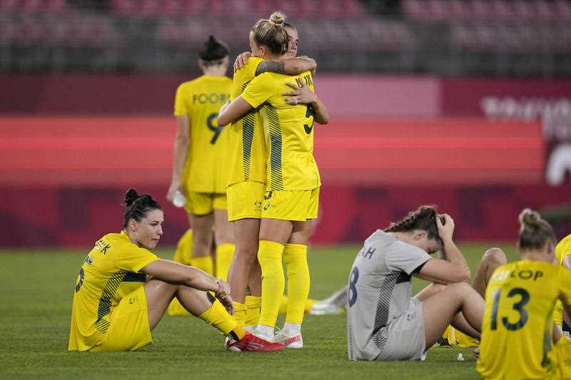Players of Australia embrace after losing 3-4 attains the United States the women's bronze medal soccer match at the 2020 Summer Olympics