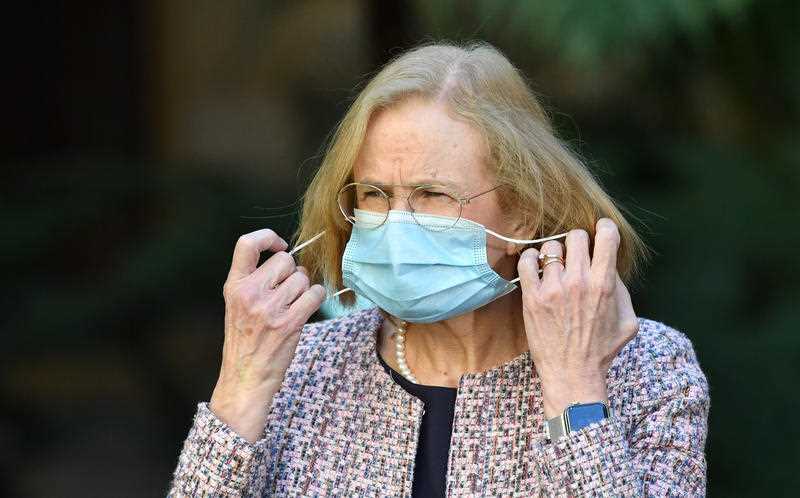 Queensland Chief Health Officer Dr Jeannette Young adjusting a face mask at a press conference to provide a COVID-19 update in Brisbane