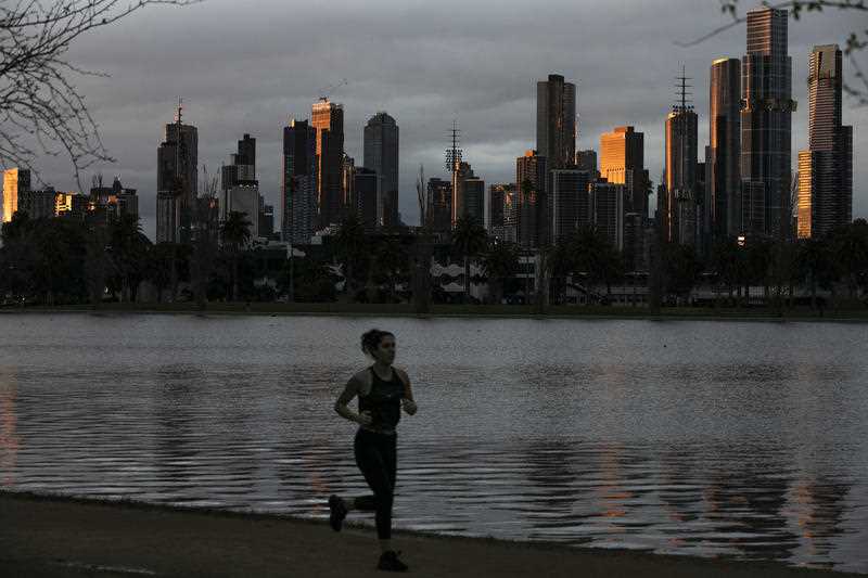 On lone woman is seen exercising at a park in Melbourne