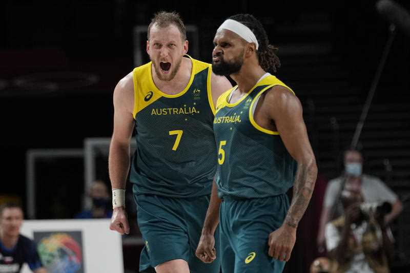 Australia's Joe Ingles (7) and Patty Mills (5) react to a score by Mills against Slovenia during the men's bronze medal basketball game at the 2020 Summer Olympics