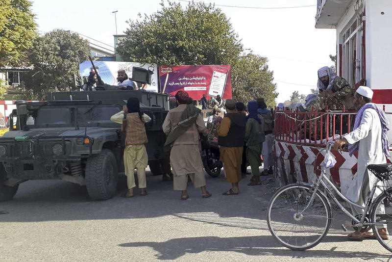 Taliban fighters stand guard in Kunduz city, northern Afghanistan