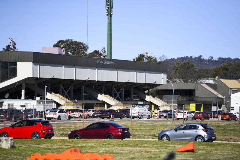 Cars form long cues as residents wait to be tested at the EPIC Drive-through COVID19 testing site in Canberra, Friday, August 13, 2021.