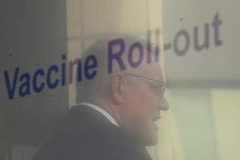 Australian Prime Minister Scott Morrison is seen reflected in a screen displaying information on Australian’s COVID19 Vaccine Roll-out as he speaks to the media during a press conference following a national cabinet meeting, at Parliament House in Canberra, Friday, August 13, 2021