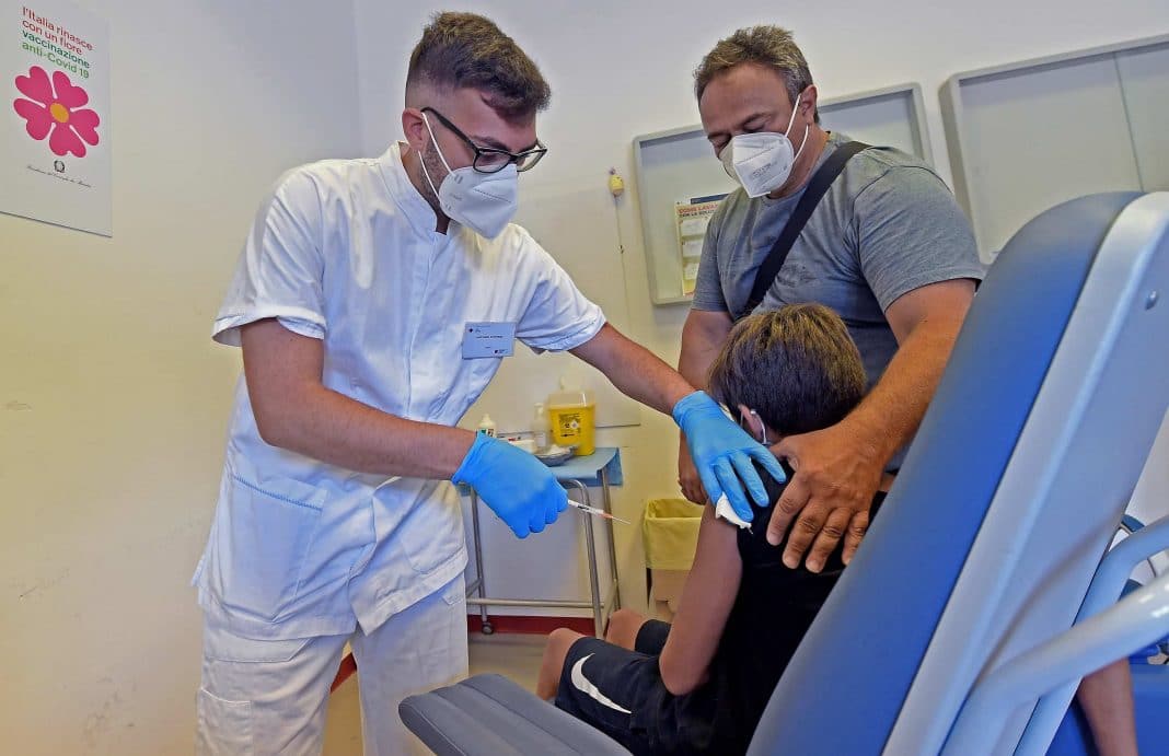 A boy receives a vaccine against Covid-19