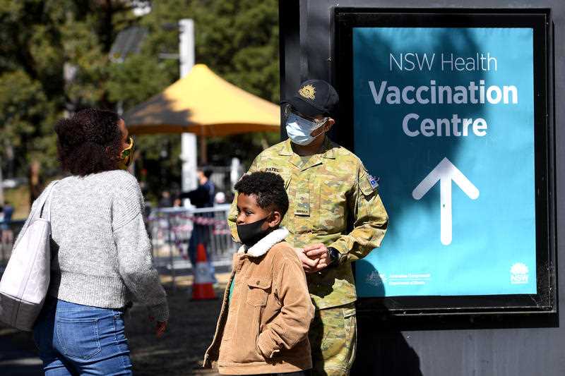 NSW Police and Australian Defence Force personnel are seen assisting NSW Health staff at a Covid vaccination clinic at Olympic Park, Sydney, Wednesday, August 18, 2021