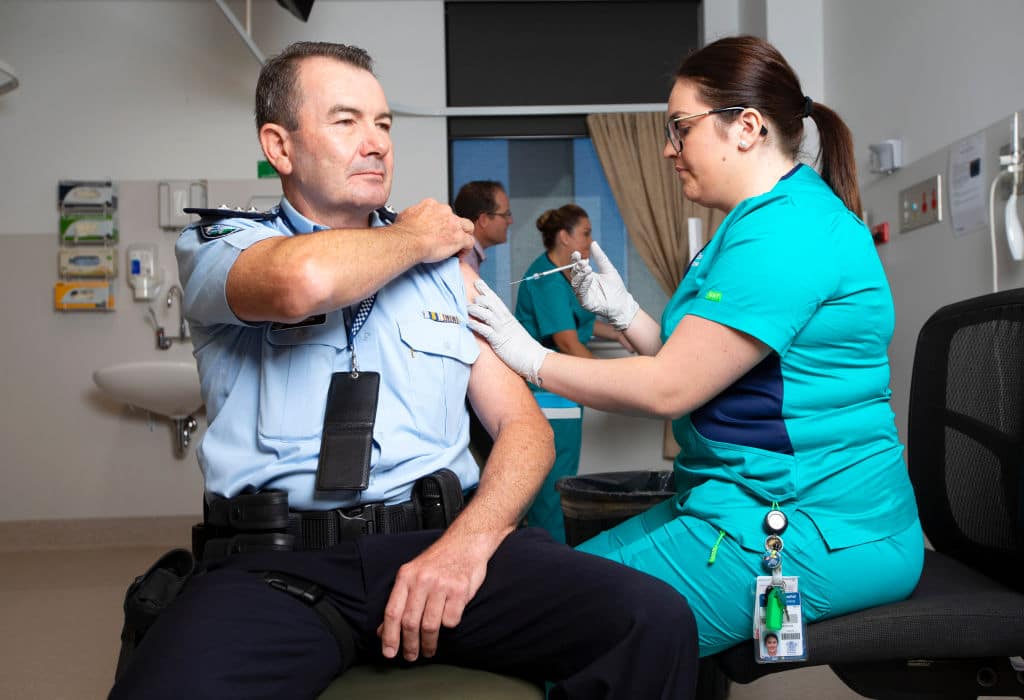 SOUTHPORT, AUSTRALIA - FEBRUARY 22: Police Inspector Owen Hortz is the first police officer to receive the Covid-19 vaccine at Gold Coast University Hospital on February 22, 2021 in Southport, Australia. The first phase of the vaccination program includes up to 1.4 million doses of the Pfizer vaccine for frontline healthcare workers, quarantine personnel and aged care centre residents and employees. (Photo by Nigel Hallett-Pool/Getty Images)