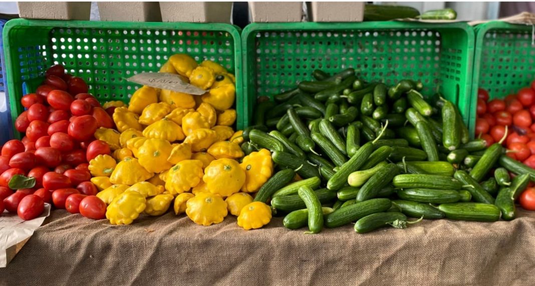 A farmers market stall with fresh seasonal vegetables