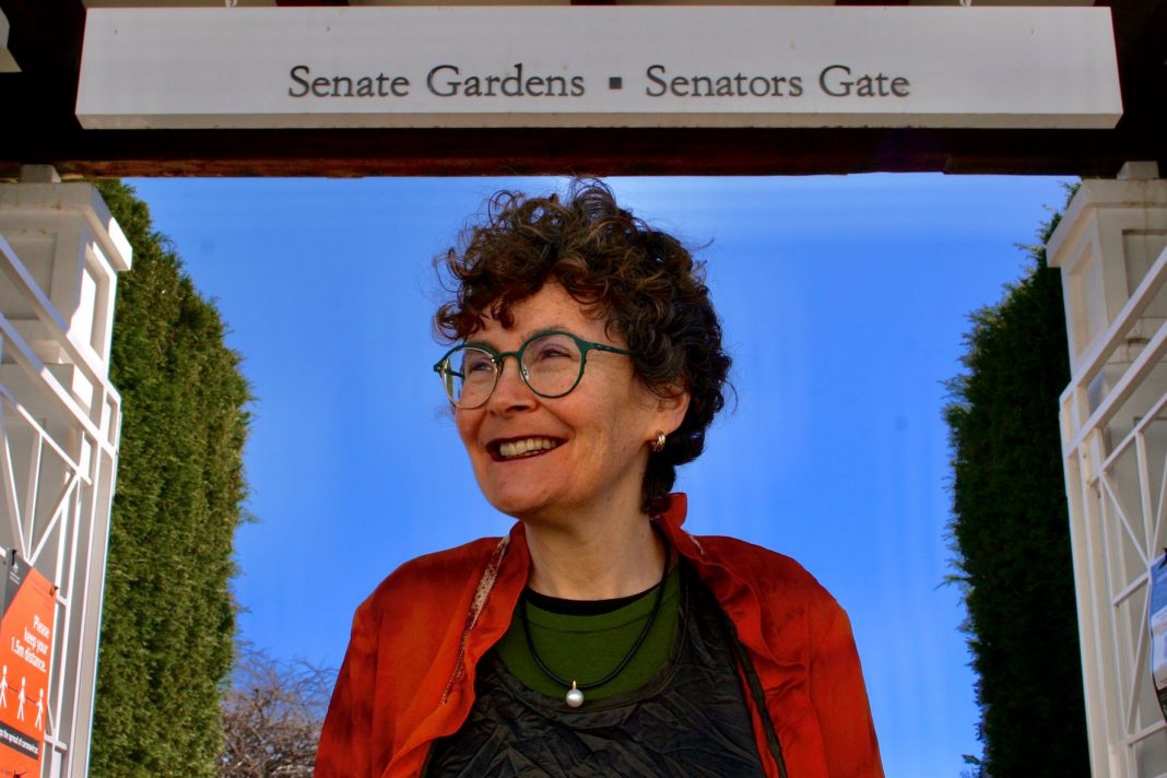 smiling middle aged woman seen at Senate Gardens at Old Parliament House Canberra