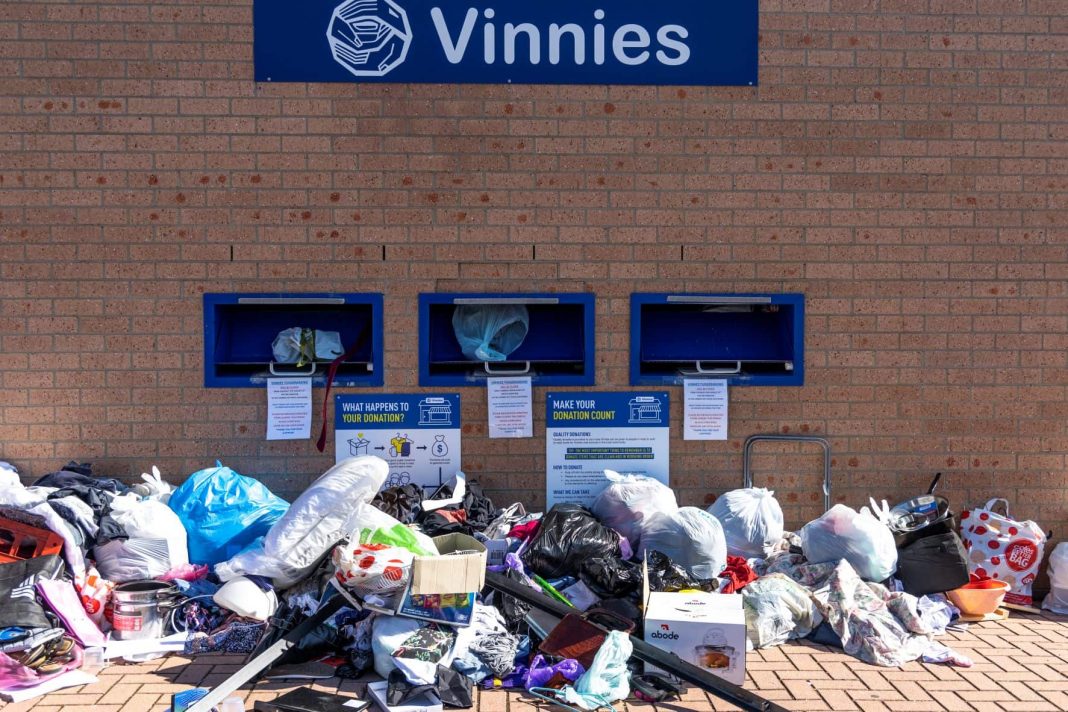 piles of donated clothes and rubbish left outside a charity op shop forced to close during lockdown