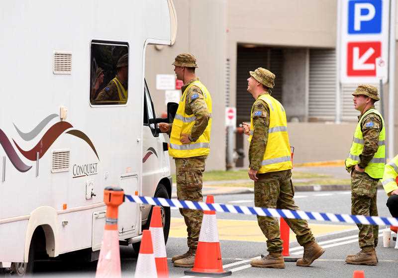Defence personnel are seen at a checkpoint on the Queensland-New South Wales border in Coolangatta on the Gold Coast