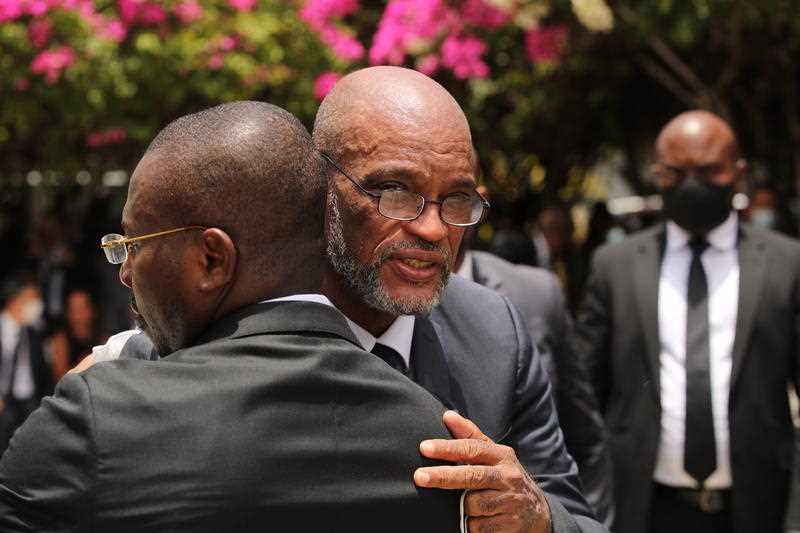 Haitian Prime Minister Ariel Henry (R) and interim predecessor Claude Joseph (L) attend a ceremony in honor of slain Haitian president Moise, in the gardens of the National Pantheon Museum of Haiti in Port-au-Prince