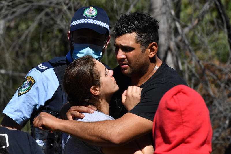 An emotional Anthony and Kelly Elfalak, the mother and father of 3 year old missing boy AJ Elfalak, hugs family and friends when they learn AJ has been found alive on the family property near Putty in the NSW Hunter region