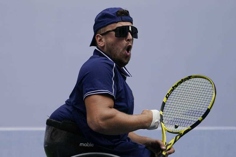 Dylan Alcott, of Australia, returns to Niels Vink, of the Netherlands, during the men's wheelchair quad singles final at the US Open tennis championships, Sunday, Sept. 12, 2021, in New York